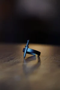 The Collection Unisex Black Adjustable Ring with Mini Sword Figure - Image 2