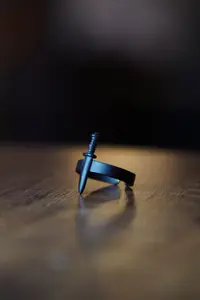 The Collection Unisex Black Adjustable Ring with Mini Sword Figure - Image 2